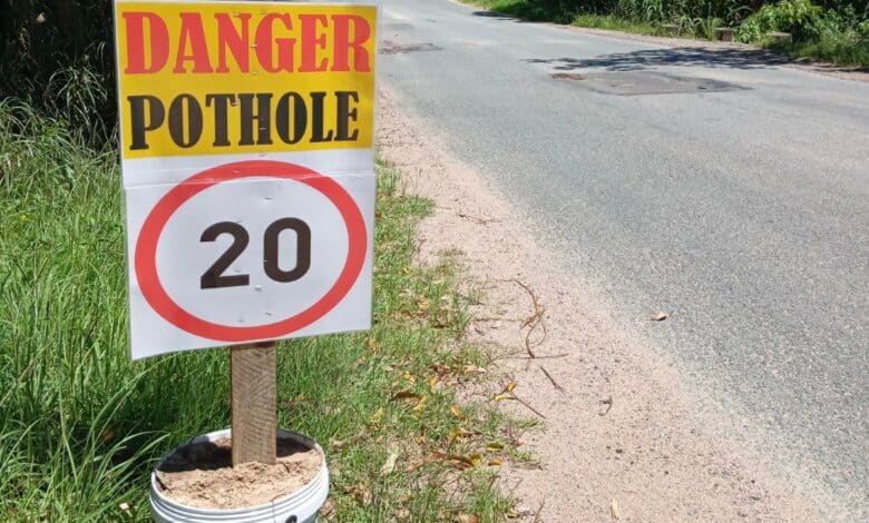 danger sign for pothole on road condtion